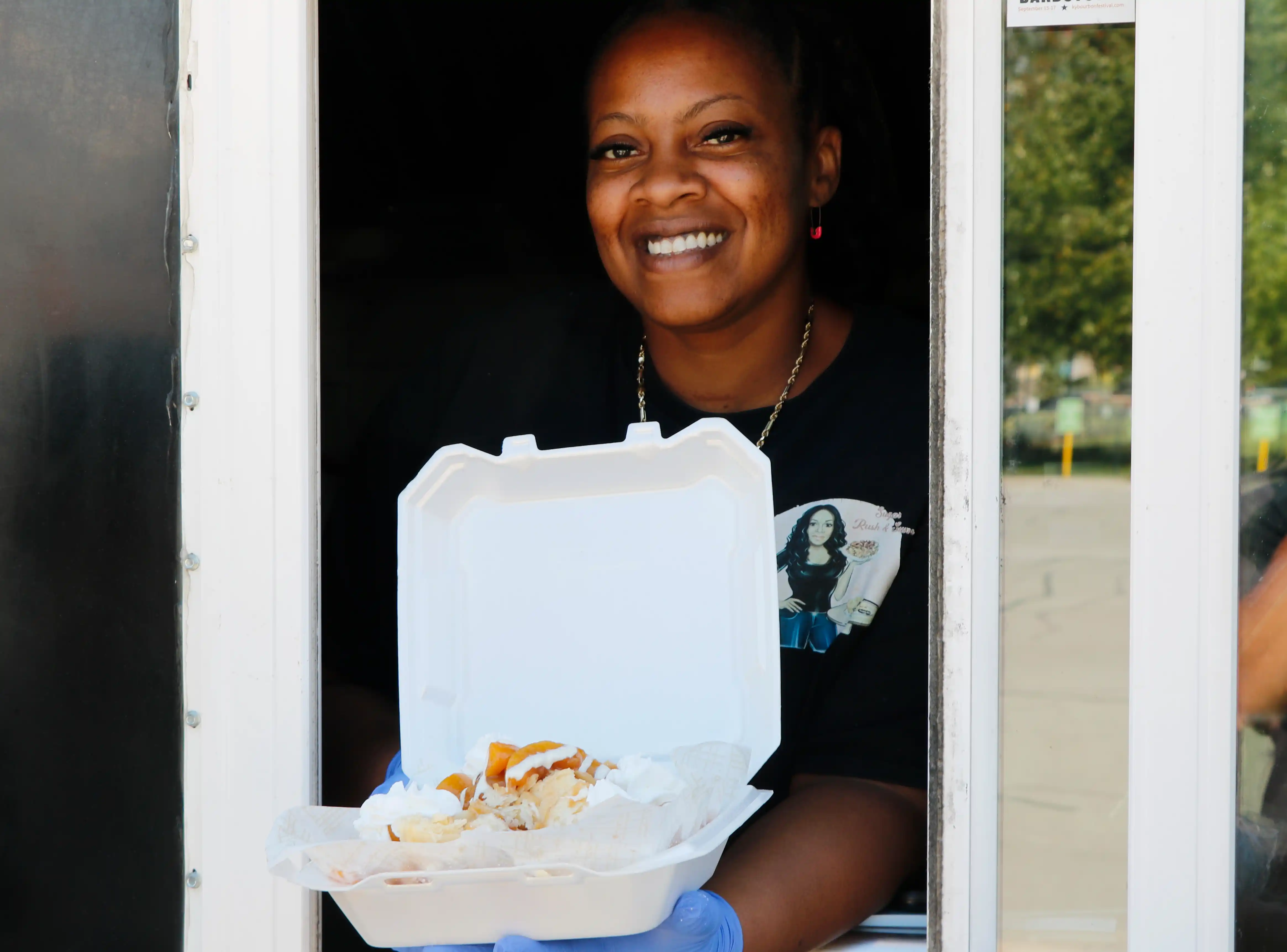 Sugar rush sum owner Terra holding peach funnel cake